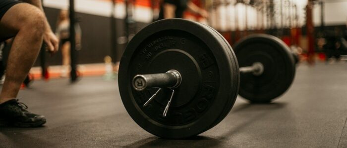 Skivstång med viktskivor på gymgolv inför ett tungt lyft